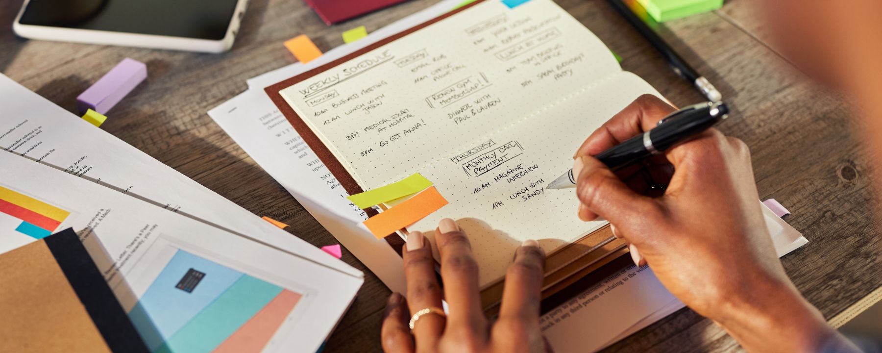 Hands of a person writing on a journal