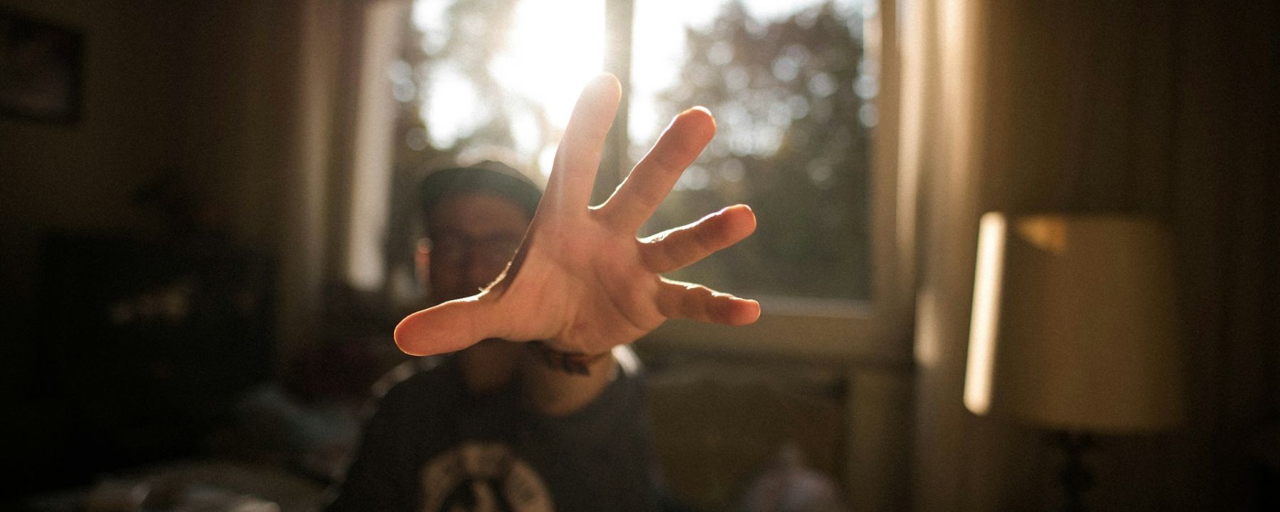Man reaching out his hand toward the camera