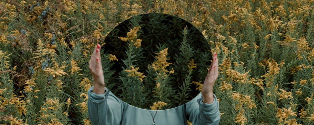 a woman holding a mirror