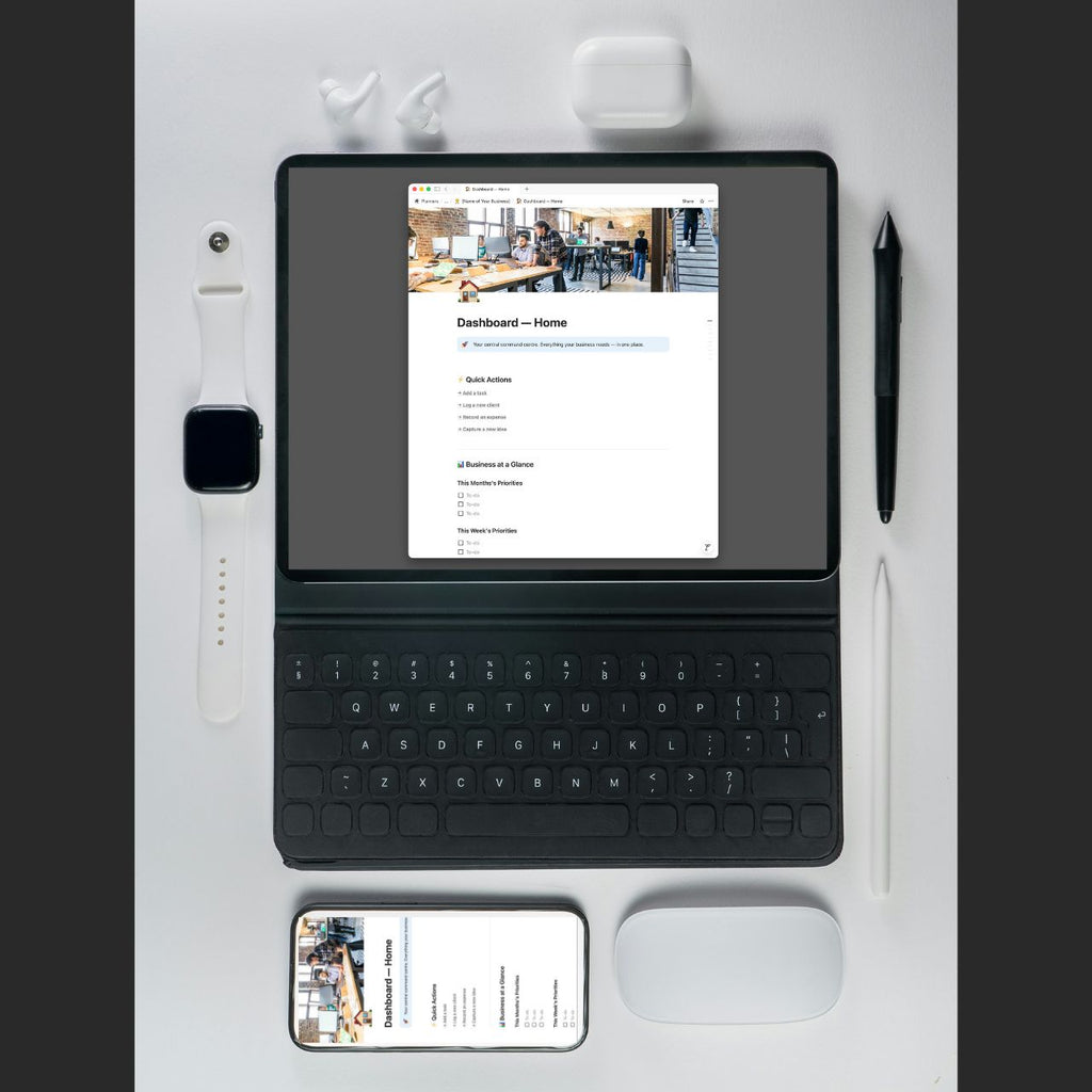 Tablet with keyboard, smartphone, mouse, and office items on a white surface